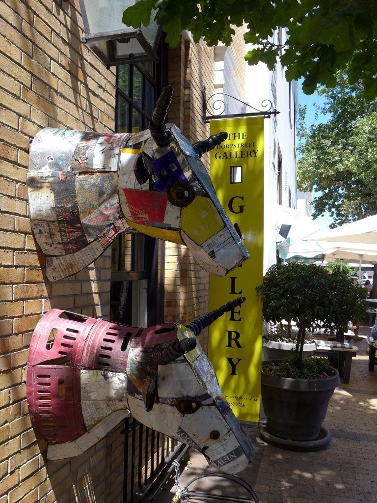 Two cow head sculptures on Dorp Street in downtown Stellenbosch, home of South African wine tour