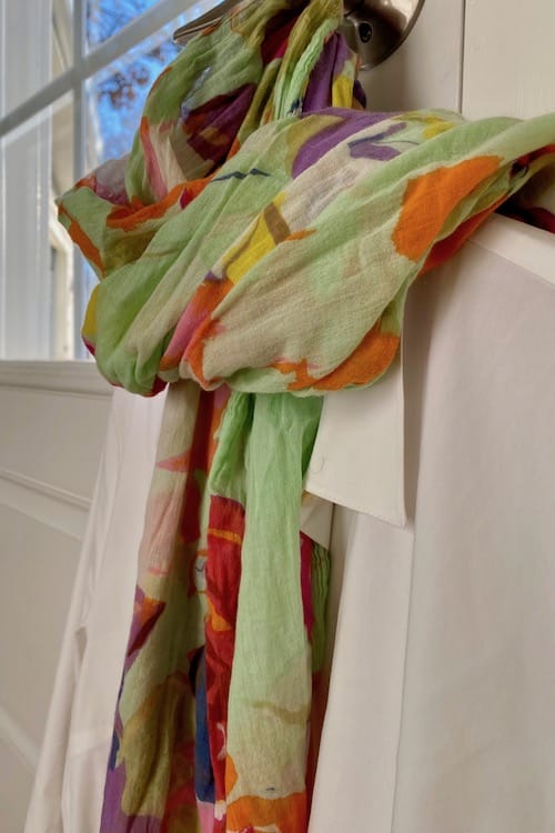 womans white shirt with colorful scarf, a key way to pack light