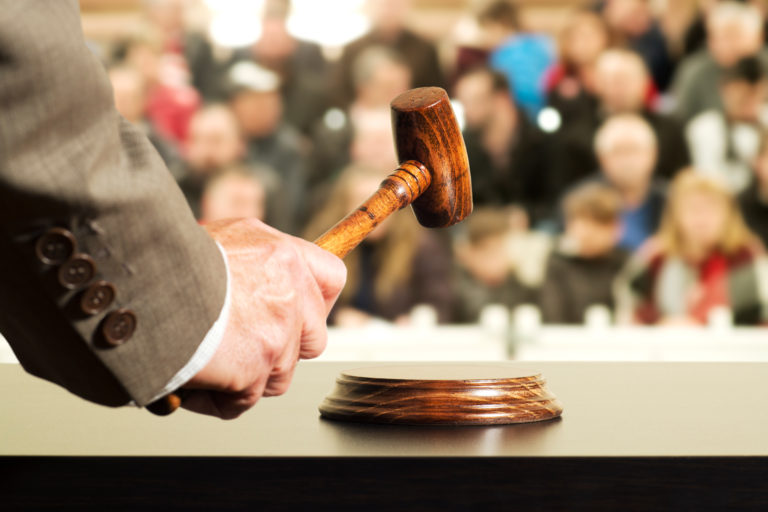 gavel with man's hand