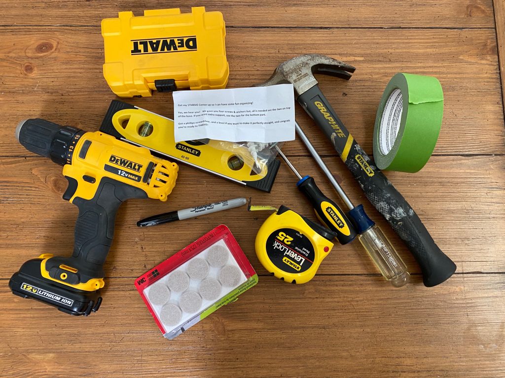 tools on a table for hanging a 1Thrive wall organizer