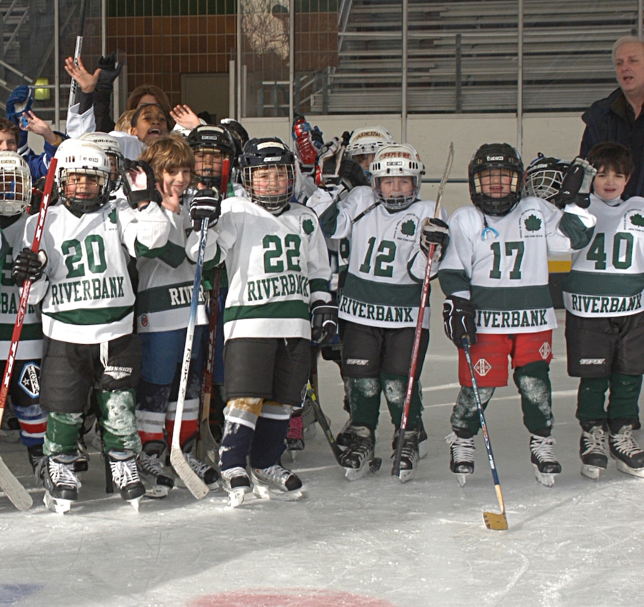 Group of children in hockey gear on the ice at Riverbank State Park in NYC