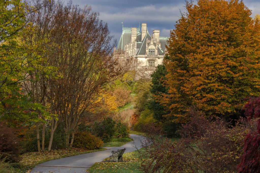 Biltmore House and fall colored trees are a highlight of an Asheville NC fall weekend getaway