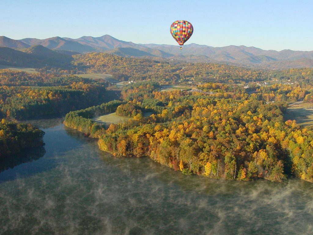 Hot air balloon soaring over Asheville NC fall foliage, a fun thing to do on a weekend getaway