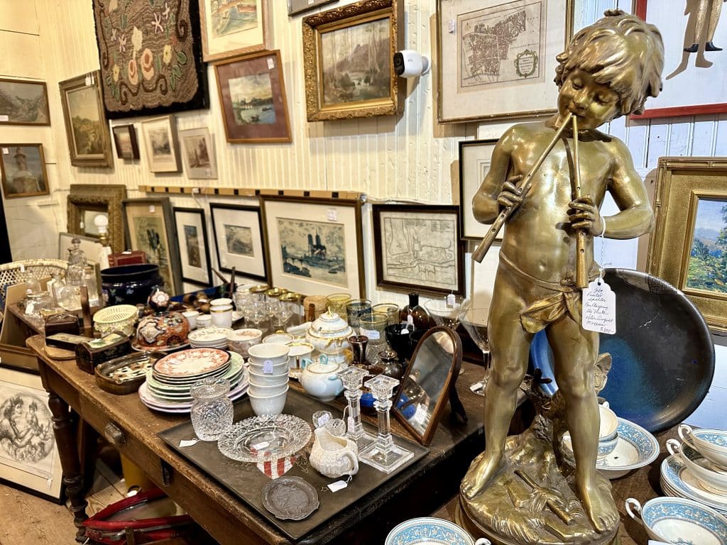 Table loaded with antiques at Beekman Arms Antique Market in Rhinebeck.